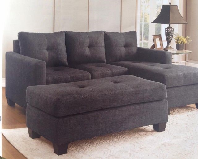 A black sofa and a white carpet